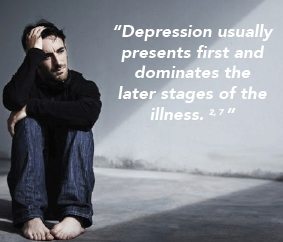 A depressed man sitting on the floor, possibly suffering from Bipolar Disorder